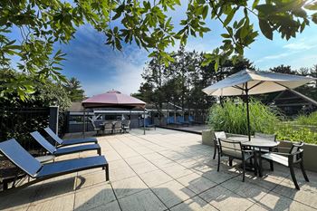 A patio with tables and chairs and umbrellas